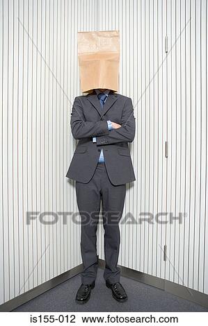 Stock Image - Businessman with paper bag on head. Fotosearch