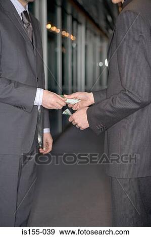 Businessmen exchanging money View Large Photo Image Stock Photo - Businessmen exchanging money. Fotosearch