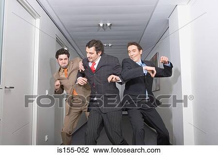 Stock Image - Businessmen fighting in corridor. Fotosearch