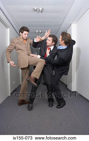Businessmen fighting in corridor View Large Photo Image Stock Image - Businessmen fighting in corridor. Fotosearch