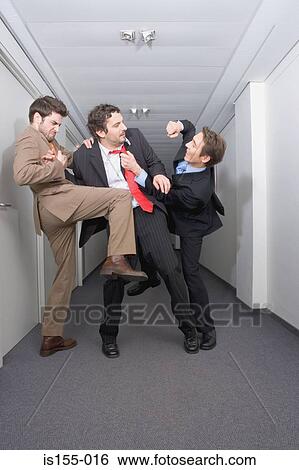 Stock Photograph - Businessmen fighting in corridor. Fotosearch