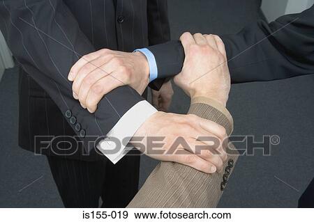 Stock Photo - Businessmen linking arms. Fotosearch