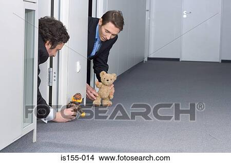 Picture - Businessmen playing with teddy bears. Fotosearch