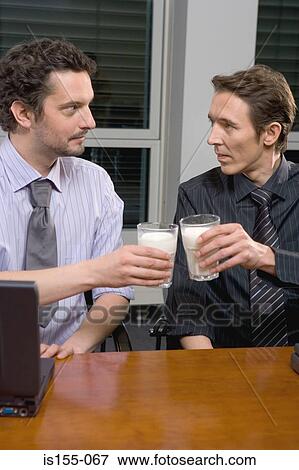 Businessmen toasting with milk View Large Photo Image Stock Photo - Businessmen toasting with milk. Fotosearch