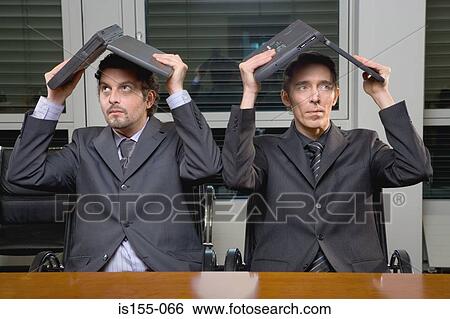 Businessmen with laptop computers above heads View Large Photo Image Stock Photograph - Businessmen with laptop computers above heads. Fotosearch