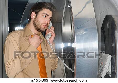 Worried man using pay telephone View Large Photo Image Stock Image - Worried man using pay telephone. Fotosearch