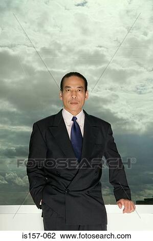 Asian businessman and cloudy sky View Large Photo Image Stock Image - Asian businessman and cloudy sky. Fotosearch