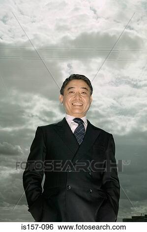 Asian businessman and cloudy sky View Large Photo Image Stock Photograph - Asian businessman and cloudy sky. Fotosearch