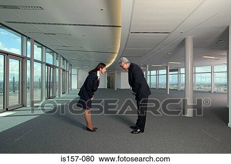 Stock Image - Asian businesspeople bowing. Fotosearch