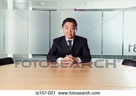 Businessman in conference room View Large Photo Image Stock Image - Businessman in conference room. Fotosearch