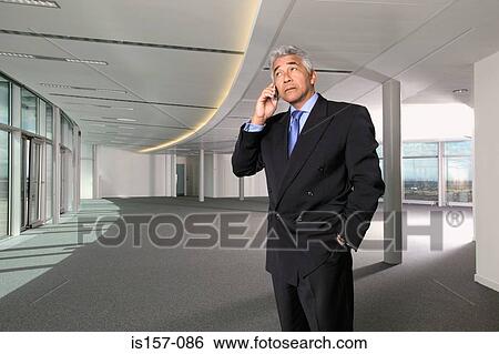 Businessman using cellular telephone View Large Photo Image Stock Photograph - Businessman using cellular telephone. Fotosearch