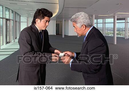 Picture - Businessmen exchanging business cards. Fotosearch