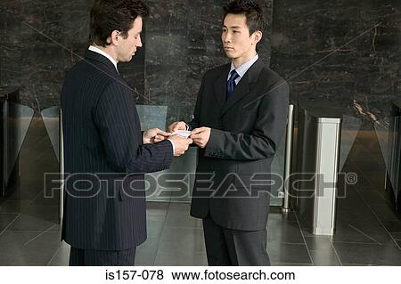 Businessmen exchanging business cards View Large Photo Image Stock Photo - Businessmen exchanging business cards. Fotosearch
