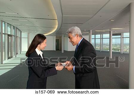 Stock Photo - Businesspeople exchanging business cards. Fotosearch