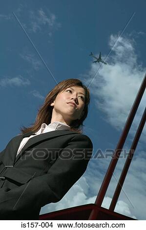 Picture - Businesswoman and cloudy sky. Fotosearch