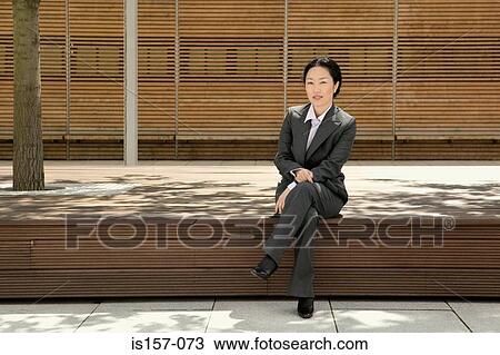 Businesswoman sitting on legde View Large Photo Image Stock Image - Businesswoman sitting on legde. Fotosearch