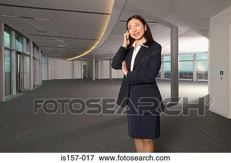 Stock Photo - Businesswoman using a cellular telephone. Fotosearch