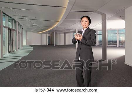 Businesswoman using a handheld computer View Large Photo Image Picture - Businesswoman using a handheld computer. Fotosearch