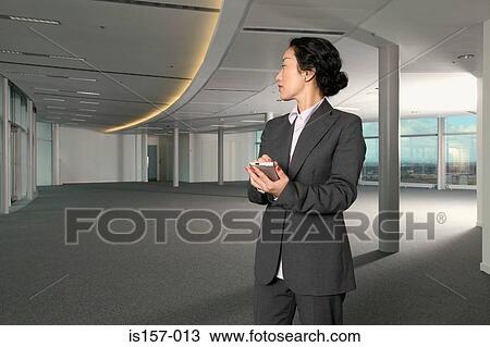 Businesswoman using a handheld computer View Large Photo Image Stock Image - Businesswoman using a handheld computer. Fotosearch