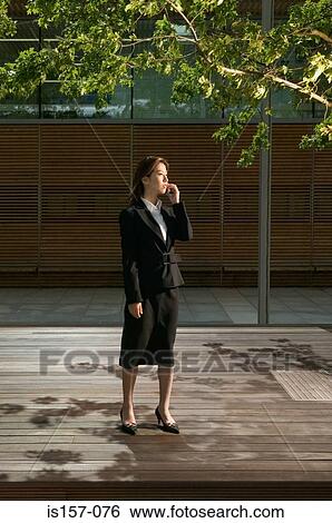 Businesswoman using cellular telephone View Large Photo Image Stock Photograph - Businesswoman using cellular telephone. Fotosearch