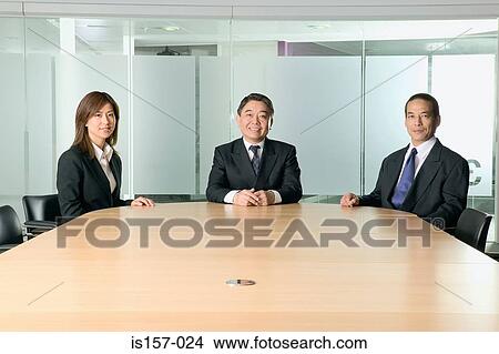 Smiling businesspeople in meeting View Large Photo Image Picture - Smiling businesspeople in meeting. Fotosearch