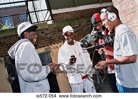 Group of young men filming View Large Photo Image Picture - Group of young men filming. Fotosearch