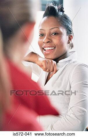 Two women talking View Large Photo Image Stock Image - Two women talking. Fotosearch