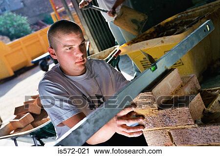 Stock Image - Young bricklayer. Fotosearch