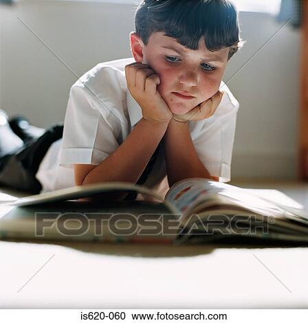 Boy reading on the floor View Large Photo Image Stock Image - Boy reading on the floor. Fotosearch
