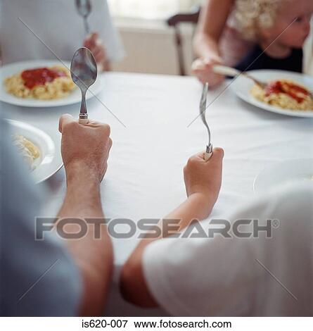 Family eating spaghetti View Large Photo Image Stock Photo - Family eating spaghetti. Fotosearch