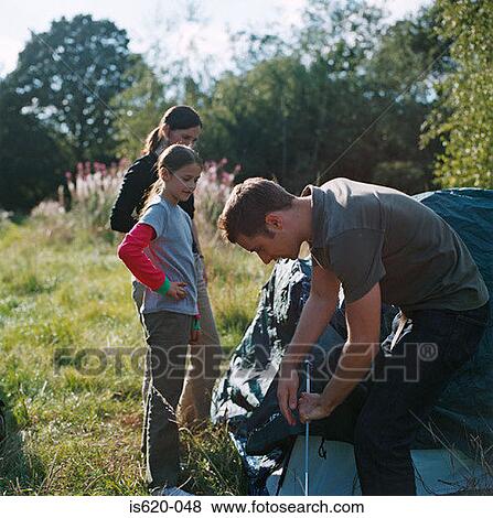 Family erecting a tent View Large Photo Image Stock Photo - Family erecting a tent. Fotosearch