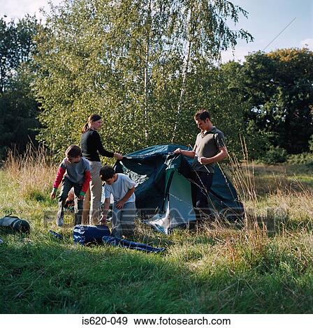 Family erecting a tent View Large Photo Image Stock Photo - Family erecting a tent. Fotosearch