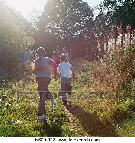 Family running in field View Large Photo Image Stock Image - Family running in field. Fotosearch
