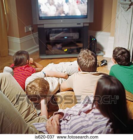 Family watching television View Large Photo Image Stock Photo - Family watching television. Fotosearch