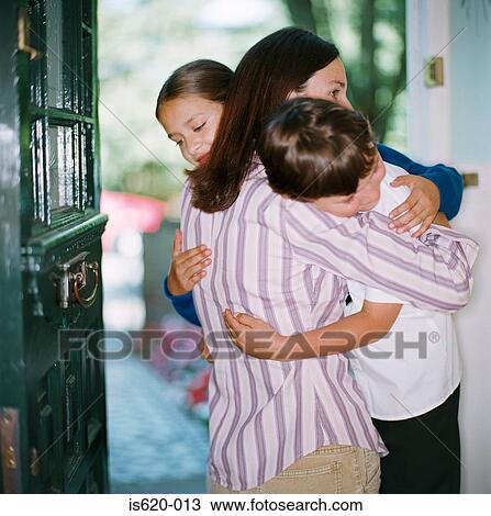 Mother hugging her children in doorway View Large Photo Image Stock Image - Mother hugging her children in doorway. Fotosearch