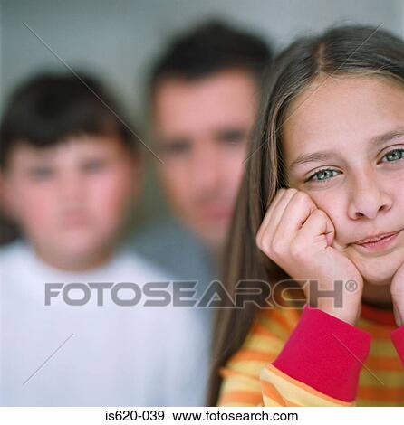 Serious looking girl with father and brother View Large Photo Image Stock Photo - Serious looking girl with father and brother. Fotosearch