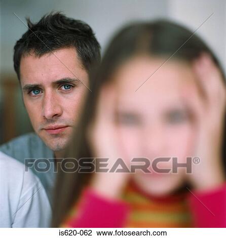 Stock Image - Stressed looking girl with father. Fotosearch