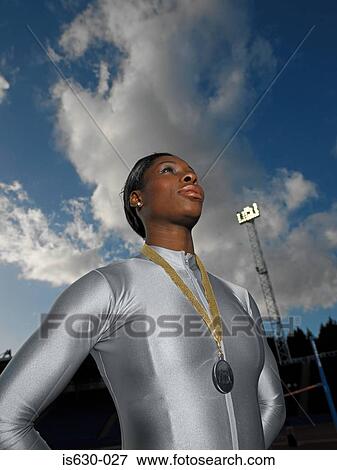 Female athlete wearing a medal View Large Photo Image Stock Photo - Female athlete wearing a medal. Fotosearch