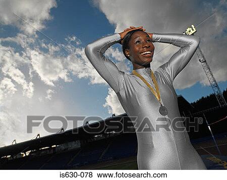 Female athlete wearing a medal View Large Photo Image Stock Photo - Female athlete wearing a medal. Fotosearch