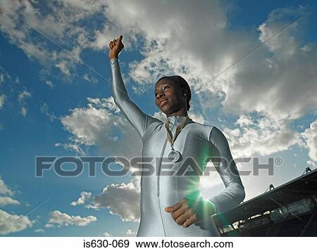 Female athlete wearing medal View Large Photo Image Stock Photo - Female athlete wearing medal. Fotosearch