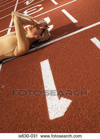 Female sprinter on finish line View Large Photo Image Stock Image - Female sprinter on finish line. Fotosearch