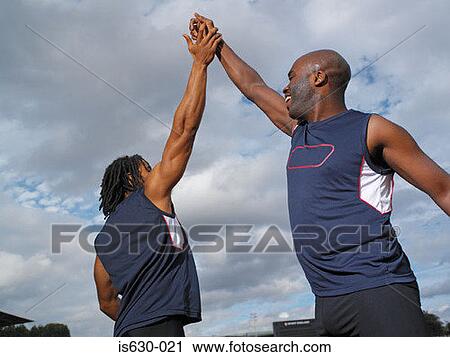 Male athletes high five View Large Photo Image Stock Image - Male athletes high five. Fotosearch