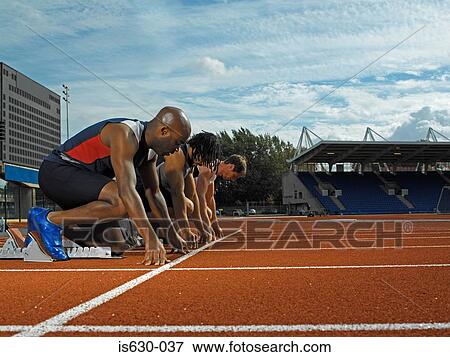 Male runners at starting line View Large Photo Image Stock Photo - Male runners at starting line. Fotosearch