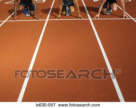 Male runners at starting line View Large Photo Image Stock Photo - Male runners at starting line. Fotosearch
