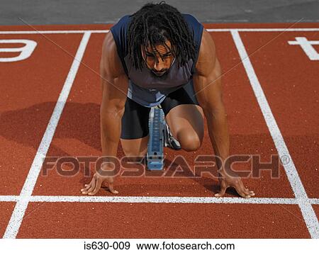 Male sprinter at starting line View Large Photo Image Stock Photo - Male sprinter at starting line. Fotosearch