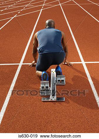 Male sprinter at starting line View Large Photo Image Stock Photo - Male sprinter at starting line. Fotosearch