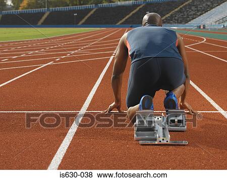 Male sprinter at starting line View Large Photo Image Stock Photo - Male sprinter at starting line. Fotosearch