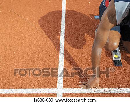 Male sprinter at starting line View Large Photo Image Stock Photo - Male sprinter at starting line. Fotosearch