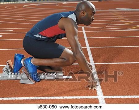 Sprinter at starting line View Large Photo Image Stock Image - Sprinter at starting line. Fotosearch