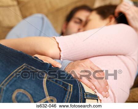 Couple hugging on sofa View Large Photo Image Stock Photograph - Couple hugging on sofa. Fotosearch